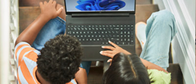 A woman and a child looking at a laptop.