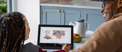 a person sitting at a table using a laptop