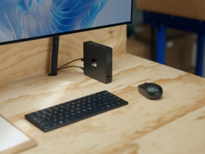 A computer monitor, keyboard, and mouse on a desk.