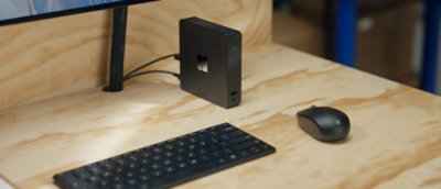 A computer keyboard and mouse on a desk.