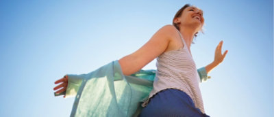 A close-up of a person raising hand and smiling