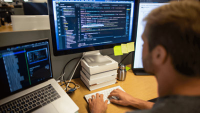 A person working at their desk in Visual Studio.
