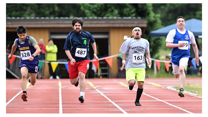 Four athletes running in the Special Olympics race