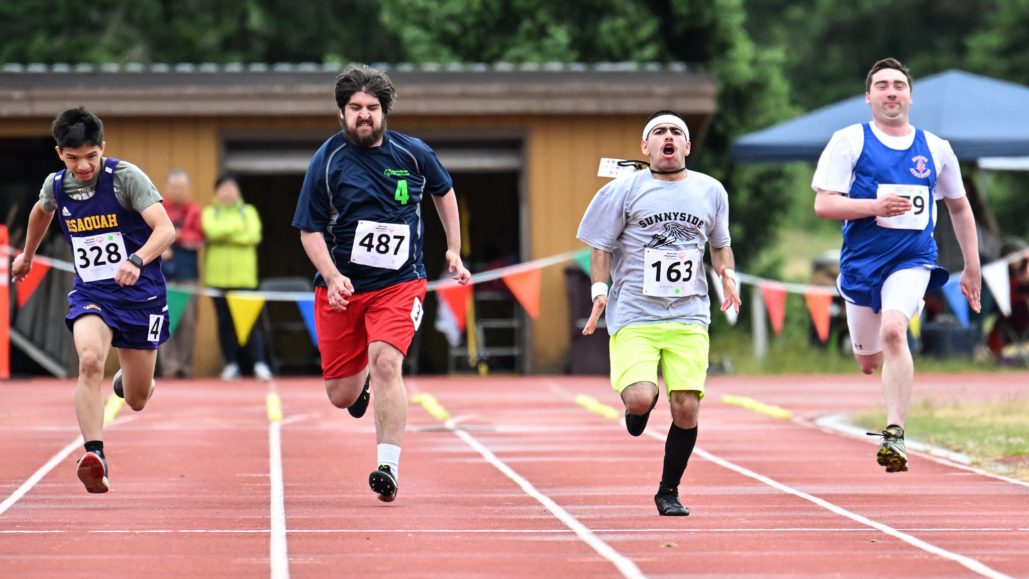 Four athletes running in the Special Olympics race