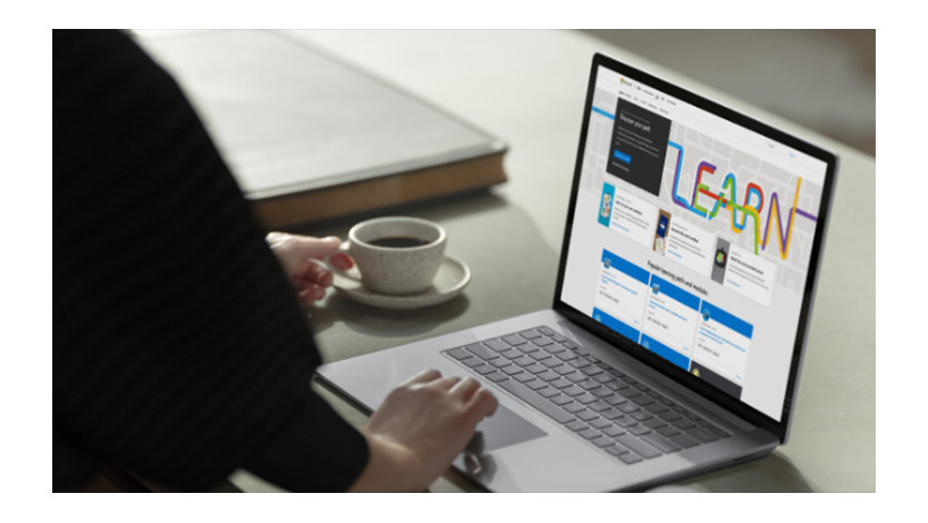 a woman close up drinking coffee and looking at microsoft learn