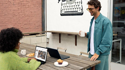 A person sitting at a table with a laptop.