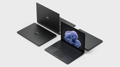 A group of laptops with a blue flower on the screen.