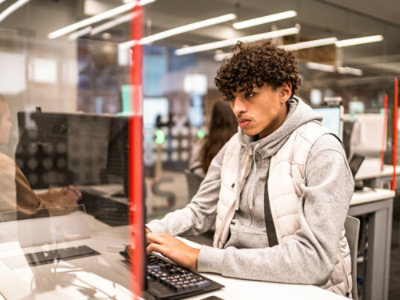 A person sitting at a desk using a computer