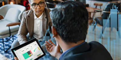 An employee of farnam street financial discussing with with something customers in Ipad