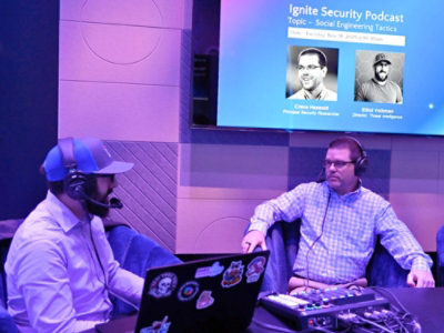 Two man sitting in chairs with microphones