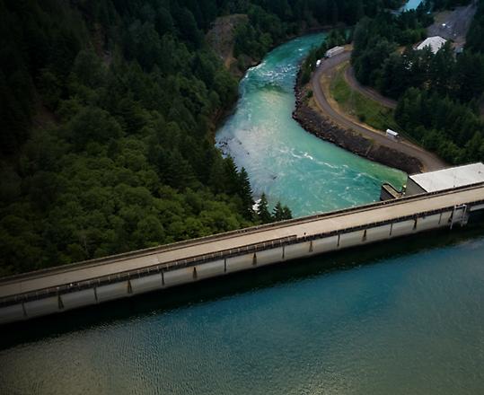 A dam separating a body of water and a river.