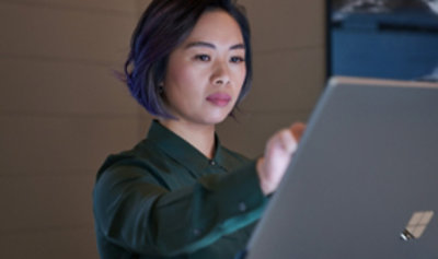 A person reaching out to use a tablet device.