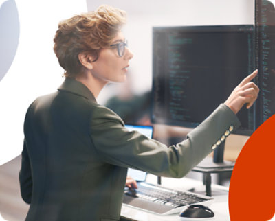 A woman is pointing at a computer screen.