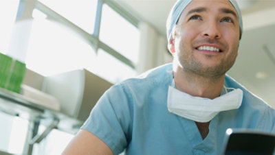 A close-up of a doctor wearing a face mask.