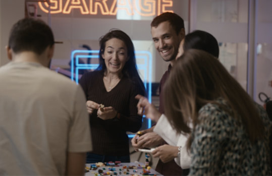 4 developers where 2 are looking towards the camera with a big smile