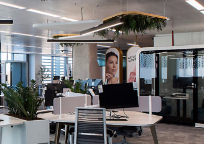 A computer on a desk in an office.