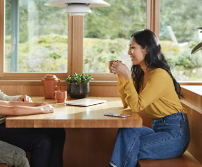 A person and another person sitting at a table