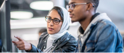 One man and woman looking at something