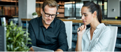 Two people looking at a tablet