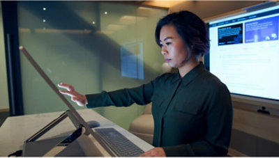 A person using a large touchscreen monitor