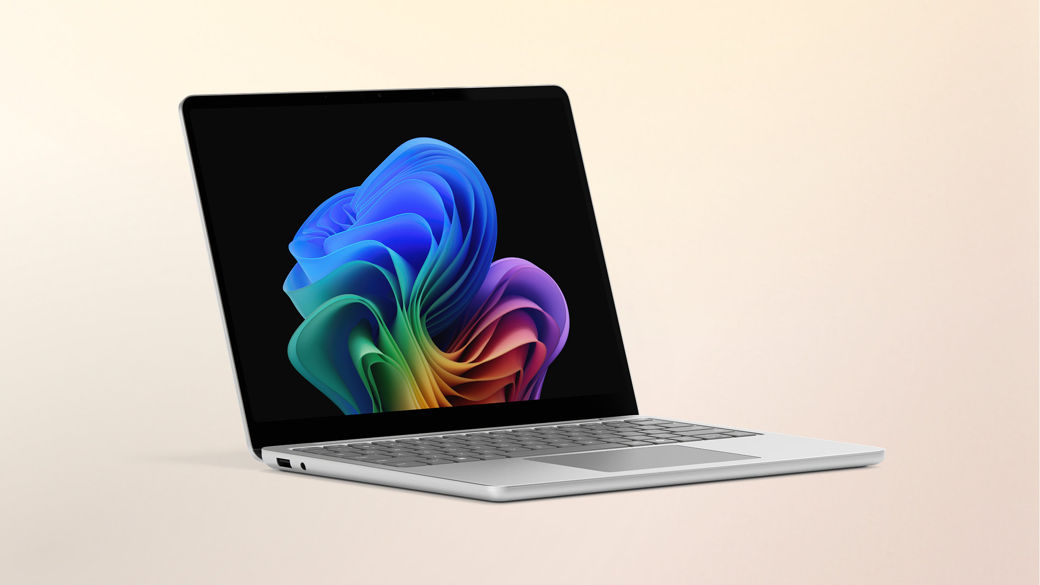 Surface Laptop Copilot+ PC 13-inch Snapdragon on a peach gradient background