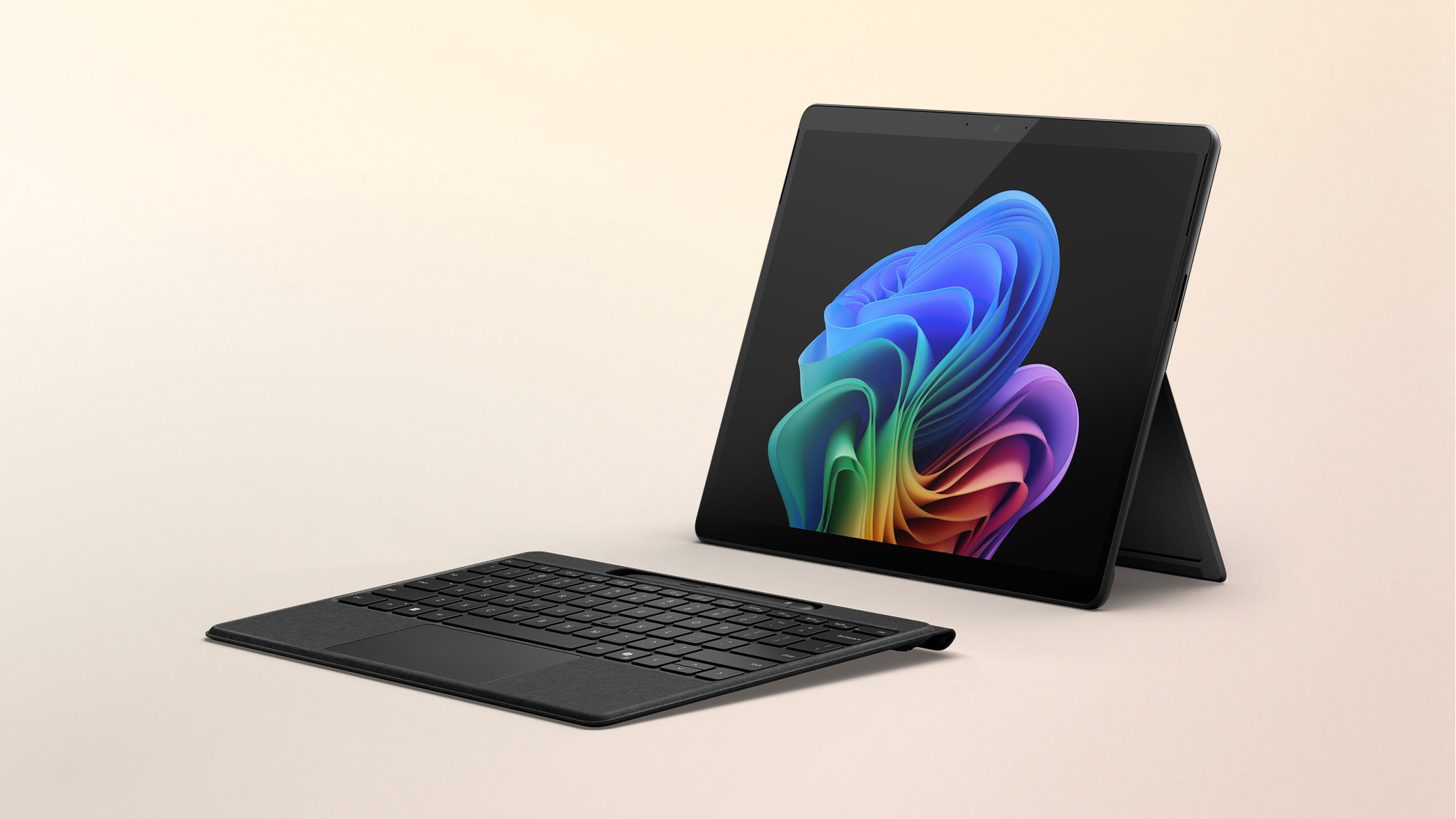 Surface Pro Copilot+ PC 13-inch Snapdragon with a Windows rainbow bloom background display on a peach gradient background