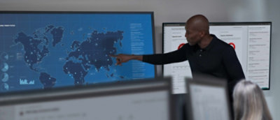  A presenter pointing to a world map during a conference.