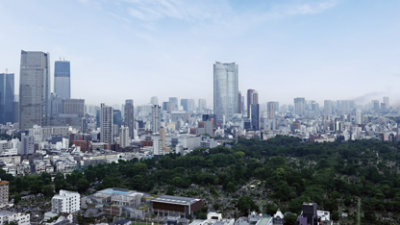 A panoramic view of a vast cityscape with numerous skyscrapers and buildings, bordered by a large expanse of greenery 