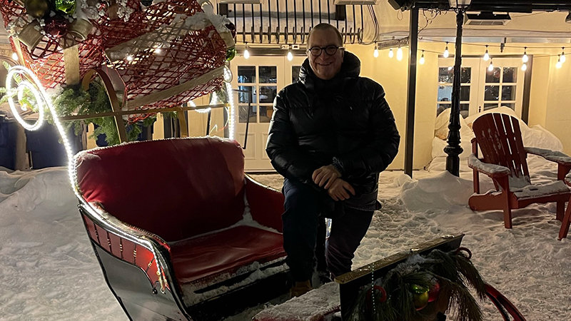 Gilles Garceau with Santa's sleigh outdoors