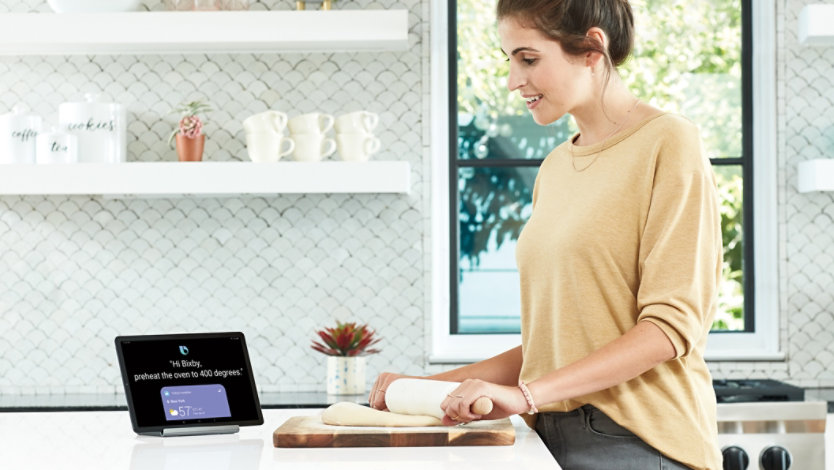 A woman using the Samsung Galaxy Tab S5e in her kitchen while baking.