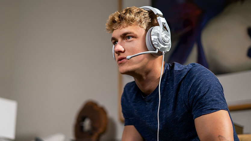 Side view of a person wearing the Turtle Beach Headphones playing a game.