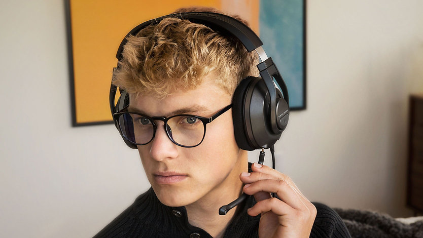 Front view of a person wearing glasses and a Turtle Beach headset.