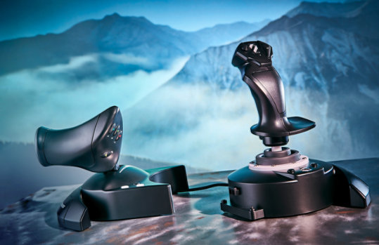 Thrustmaster T Flight Full Kit X on table with mountainous scenery in background.