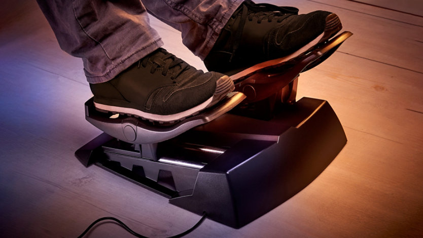 A person's feet using the Thrustmaster Xbox T Flight Full Kit rudder pedals.