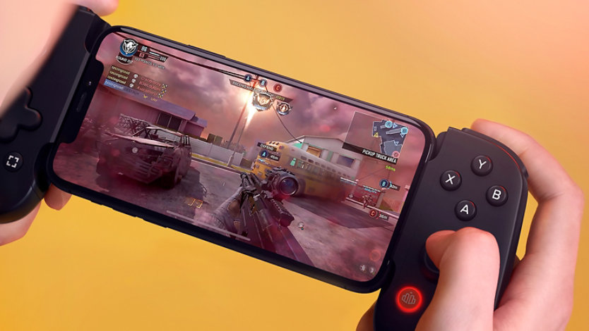 Close up view of hands playing a video game with a smartphone and Backbone controller.