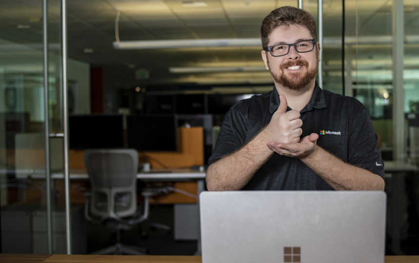 A man providing tech support via American Sign Language. 