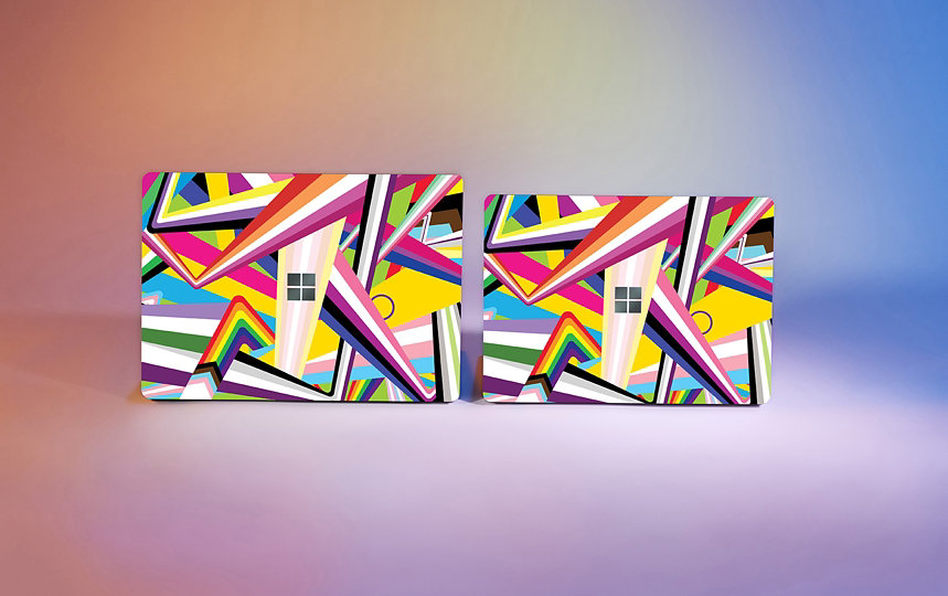 Two Surface laptops covered in the 2021 Pride skin featuring all the flag colors of the L G B T Q I + community.