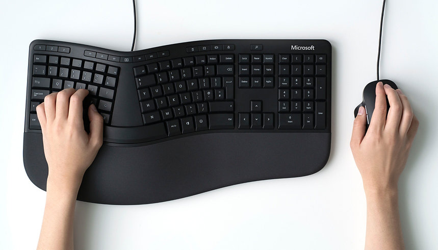 A person using an ergonomic keyboard and mouse.
