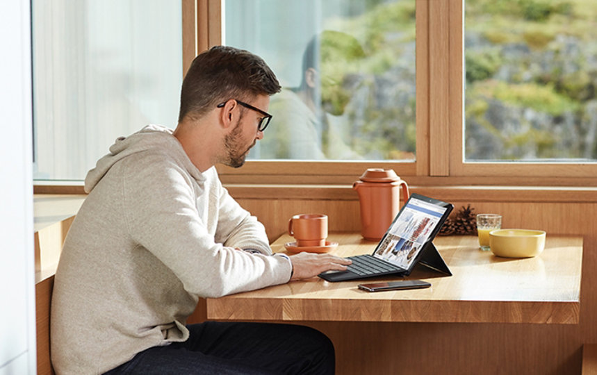 A man working at home on a surface device