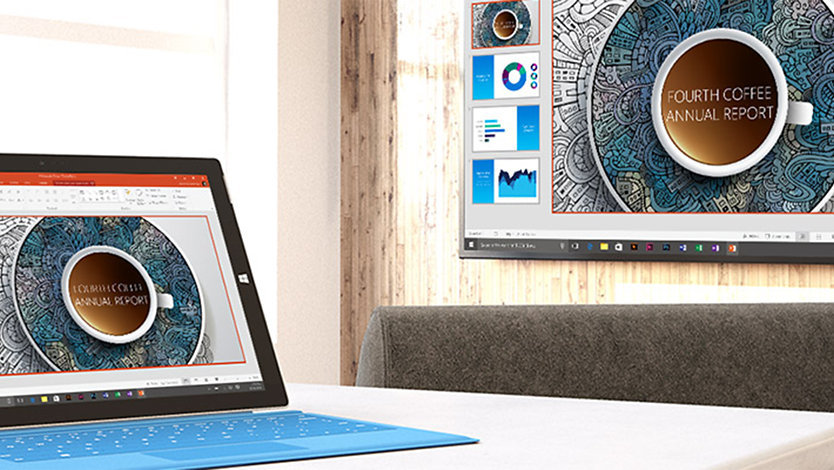 A Surface device on a desk and a monitor.