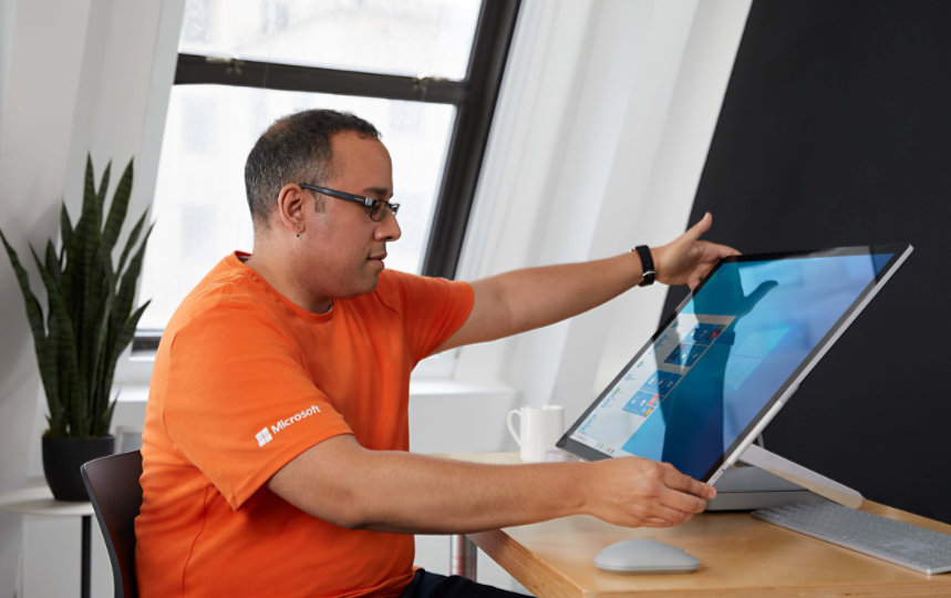 A person adjusting the screen of a Surface Studio device. 