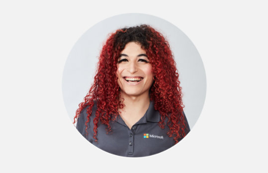 A person in a Microsoft shirt smiling