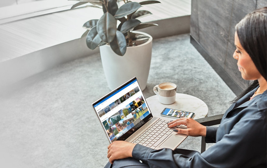 A woman using a Windows 10 laptop with OneDrive