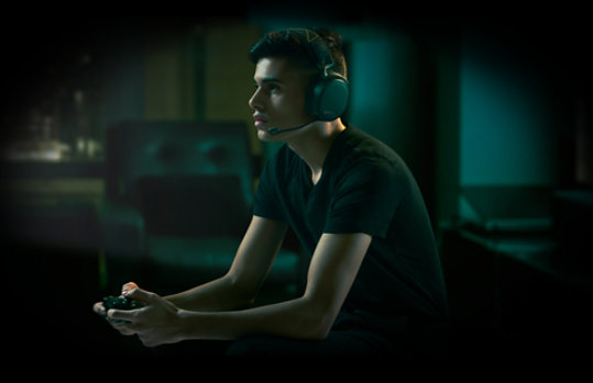 Person playing Xbox while wearing Steel Series Arctis 9X Headset.