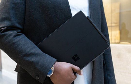 Man holding a Surface Pro 7 device.
