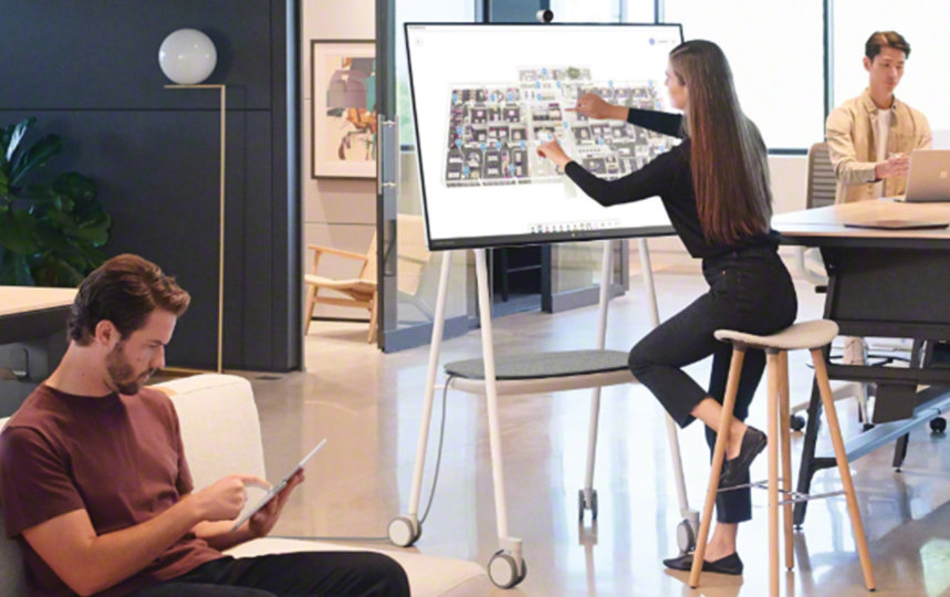 Steelcase Roam Mobile Stand holding a Surface Hub 2S in a workspace.