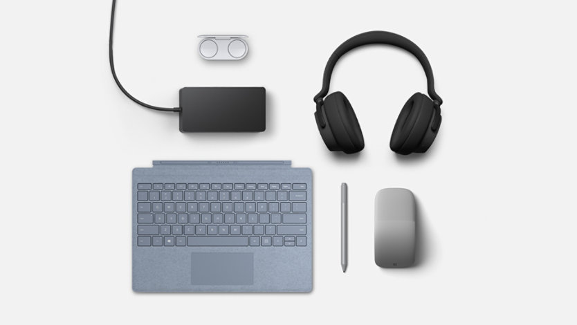 Surface Type Cover in ice blue, Pen and Arc Mouse in platinum, Headphones in matte black, Earbuds in glacier and Dock 2. 