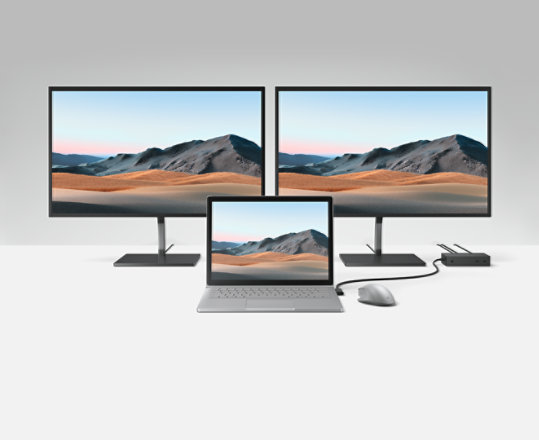 Varios monitores y un portátil conectados a Surface Dock 2.