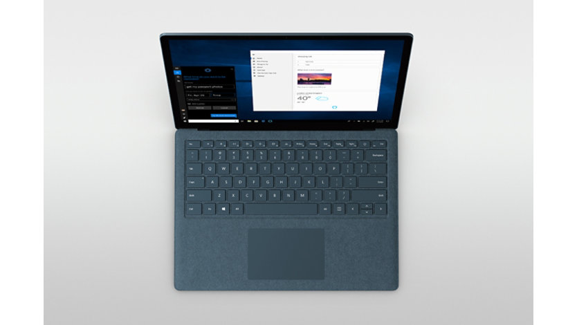 Top down view of a surface laptop with the Cortana personal assistant app on screen.