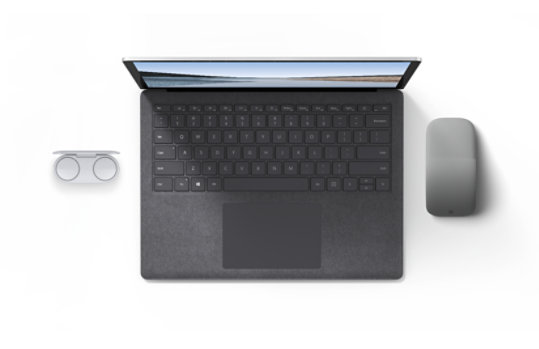 A Surface Laptop next to Surface Earbuds and a Surface Arc Mouse.